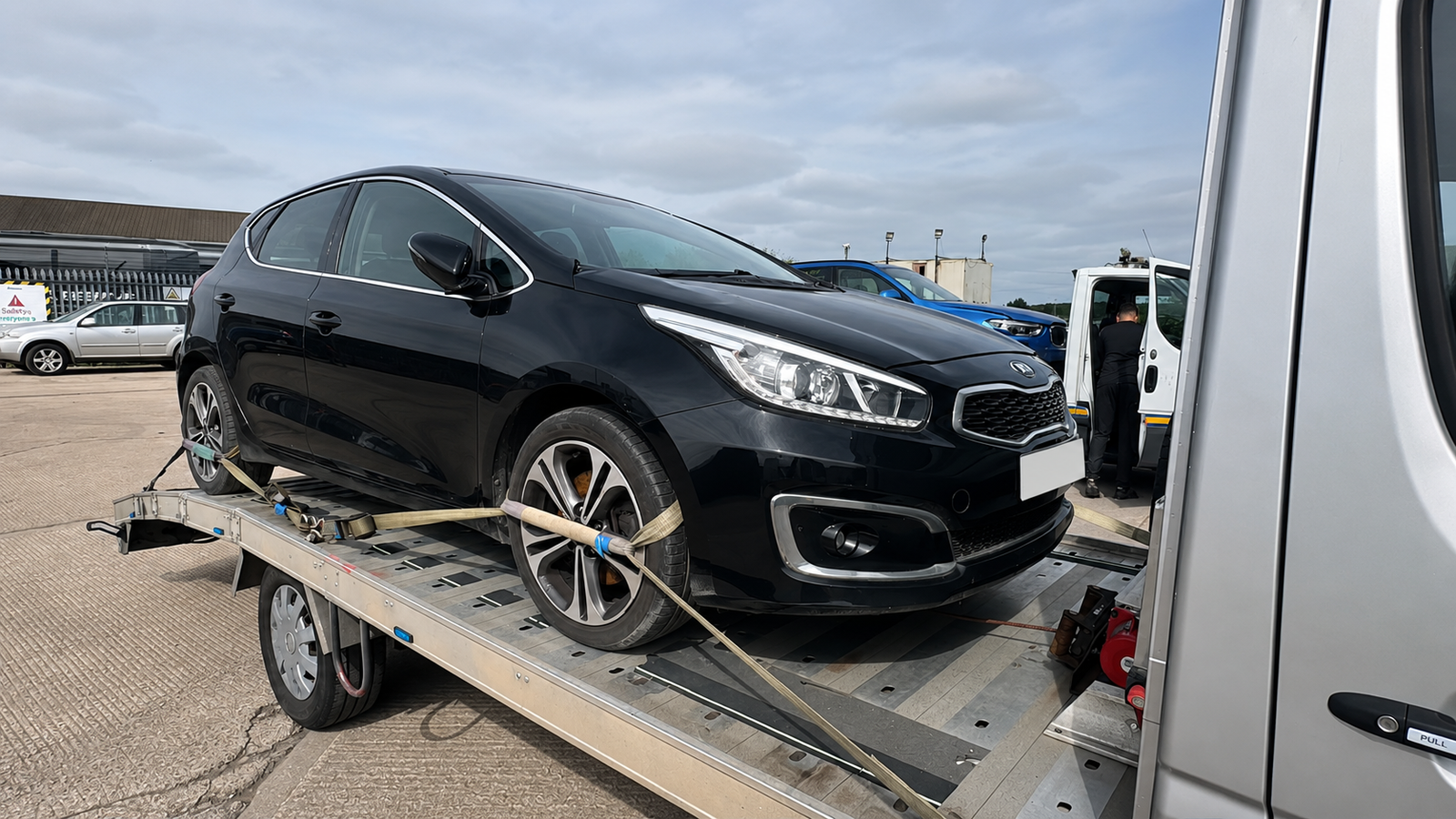 Kia hatchback on recovery transporter